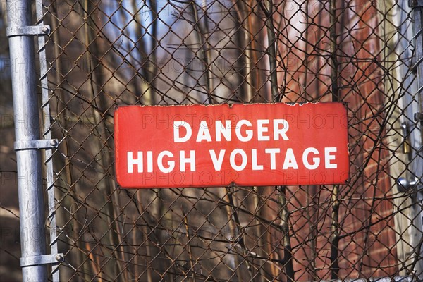 Danger High Voltage sign on fence. Date : 2007