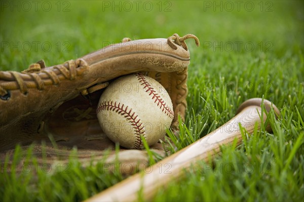 Baseball equipment laying on grass. Date : 2006