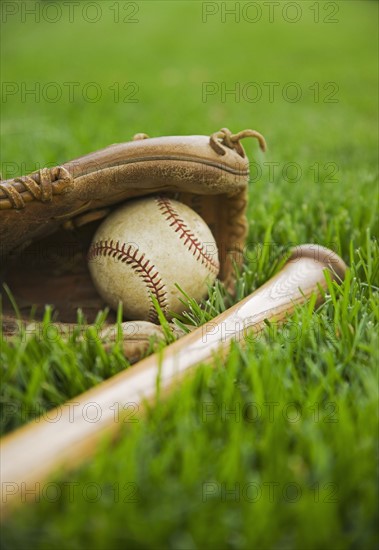 Baseball equipment laying on grass. Date : 2006