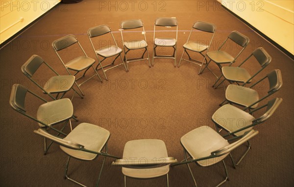 Empty folding chairs in circle. Date : 2007