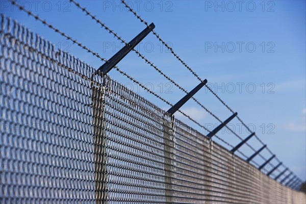Metal fence with barbed wire. Date : 2007