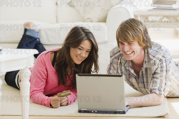 Couple looking at laptop. Date : 2007