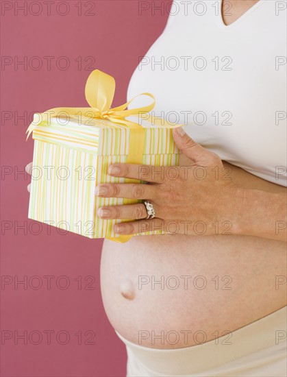 Pregnant woman holding gift. Date : 2007