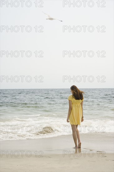 Woman walking on beach. Date : 2007