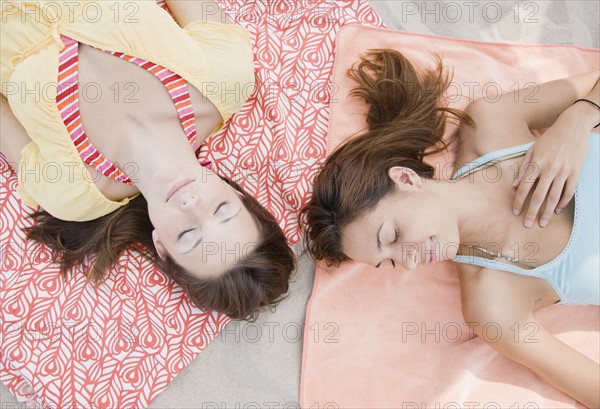 Women laying on beach blankets. Date : 2007