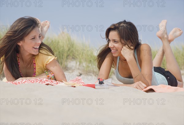 Women laying on beach blankets. Date : 2007