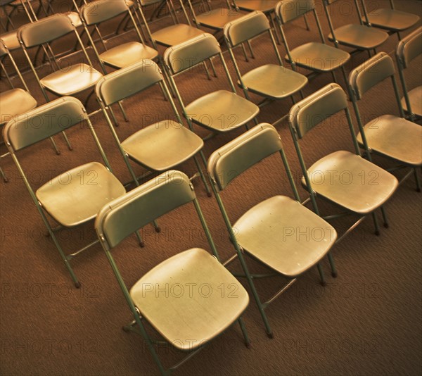 Empty folding chairs in rows. Date : 2007