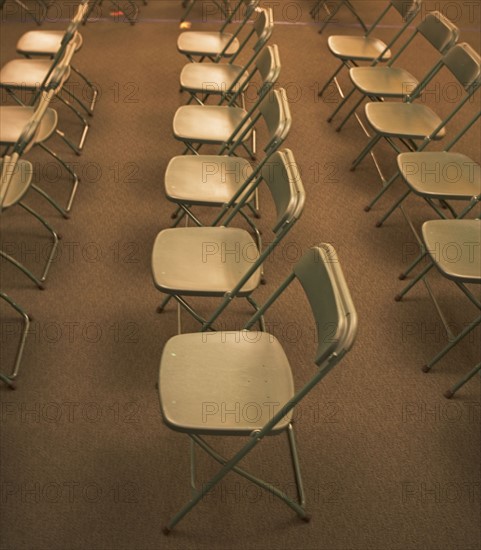 Empty folding chairs in rows. Date : 2007