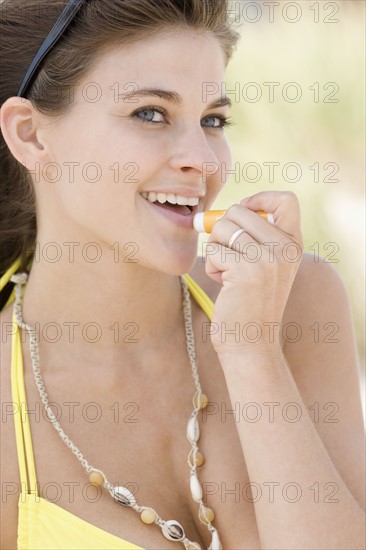 Woman applying lip balm. Date : 2007