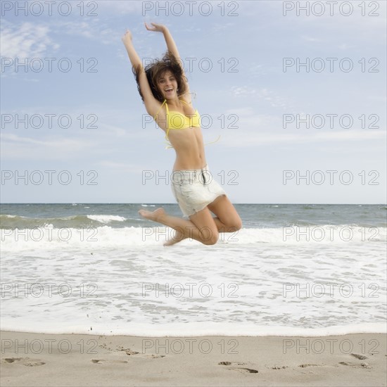 Woman jumping at beach. Date : 2007