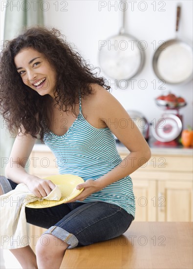 Woman drying off dish. Date : 2007