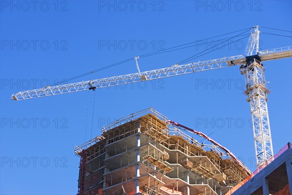 Low angle view of construction site and crane. Date : 2007