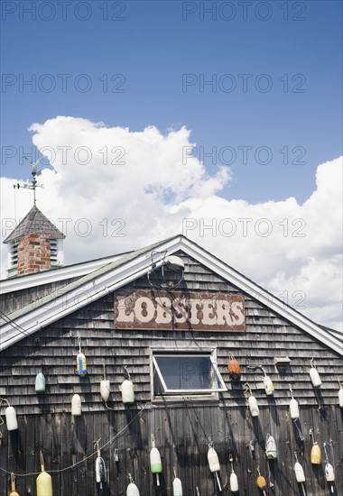 Buoys hanging on shingled building, Maine, United States. Date : 2007