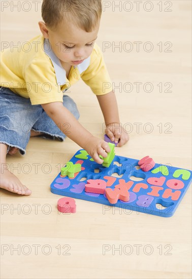 Baby playing with foam letters. Date : 2007