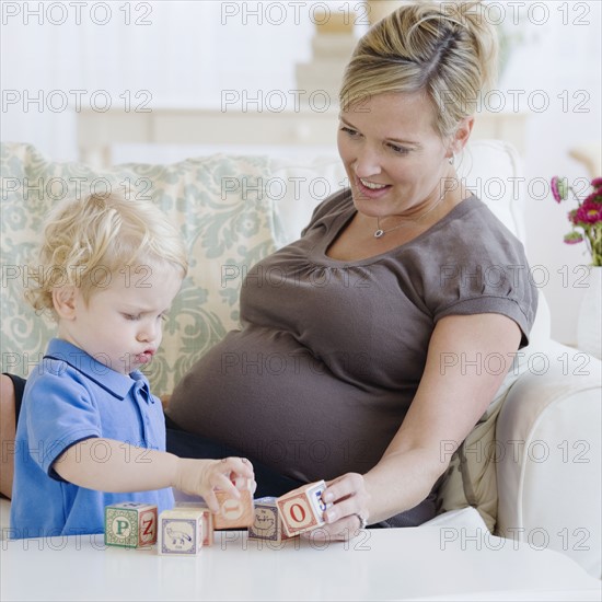 Pregnant mother playing with toddler. Date : 2007