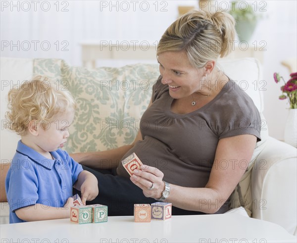 Pregnant mother playing with toddler. Date : 2007