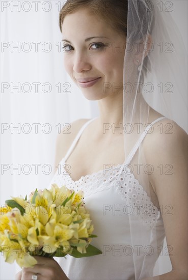 Bride holding bouquet of flowers. Date : 2007