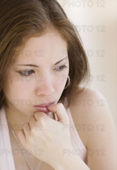 Close up of woman biting thumb. Date : 2007