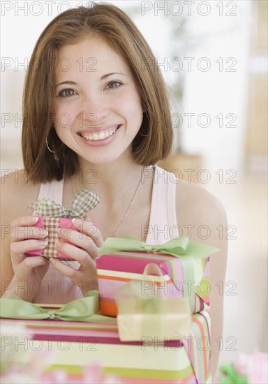 Woman next to stack of gifts. Date : 2007