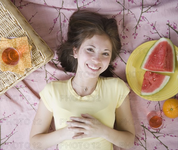 Woman laying on picnic blanket. Date : 2007