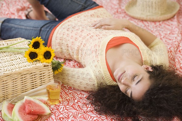 Woman laying on picnic blanket. Date : 2007