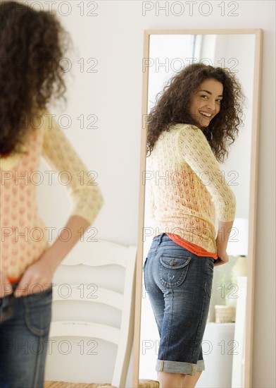 Woman looking in mirror