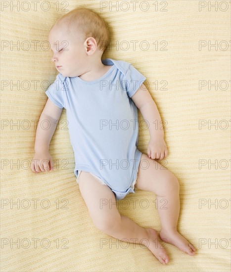 Baby sleeping on bed. Date : 2007