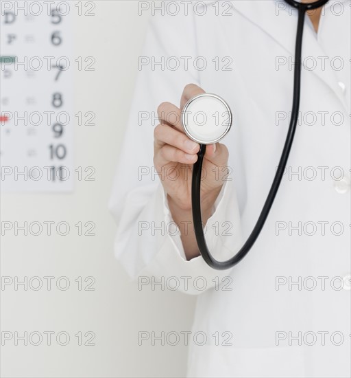 Doctor holding stethoscope. Date : 2007