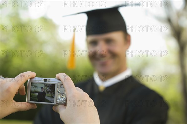 Male graduate having photograph taken. Date : 2007