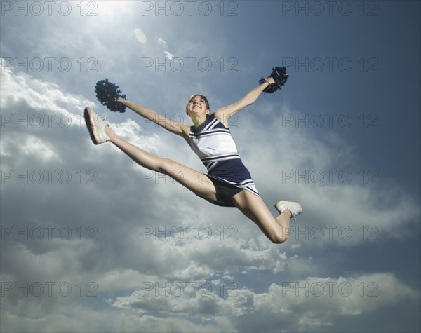 Low angle view of cheerleader jumping. Date : 2007