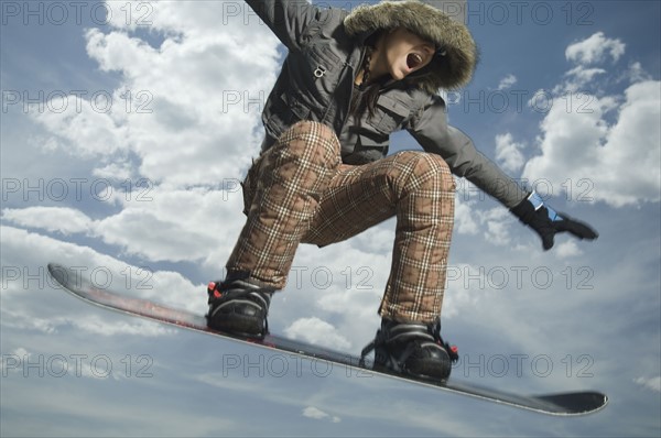 Low angle view of snowboarder jumping. Date : 2007