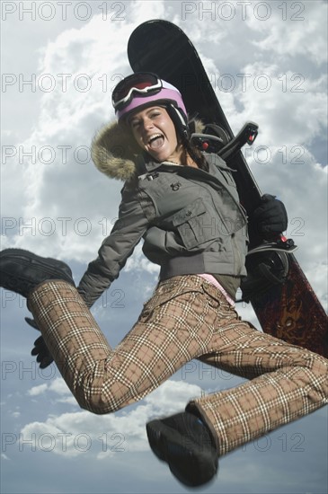 Low angle view of snowboarder jumping. Date : 2007