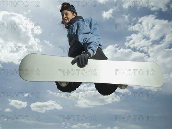 Low angle view of snowboarder jumping. Date : 2007