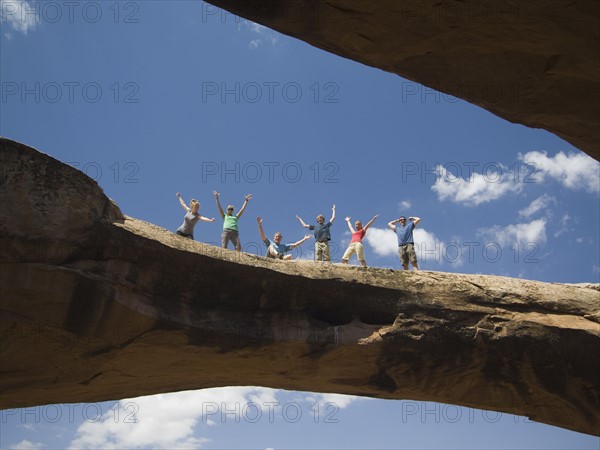 People cheering on rock formation. Date : 2007