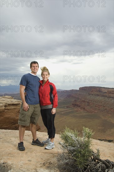 Couple standing at edge of cliff. Date : 2007