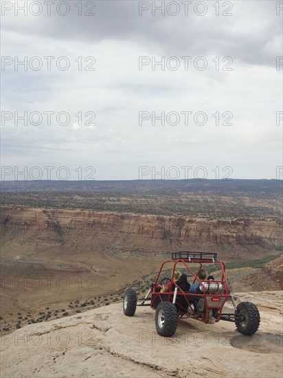 People in off-road vehicle at edge of cliff. Date : 2007