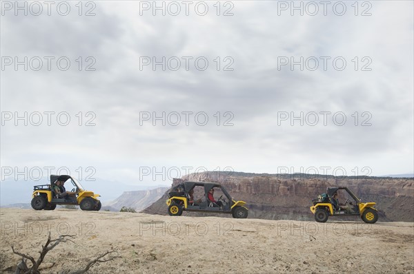 People in off-road vehicles on rock formation. Date : 2007