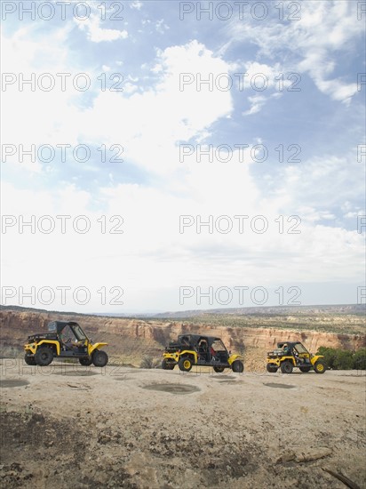 People in off-road vehicles on rock formation. Date : 2007