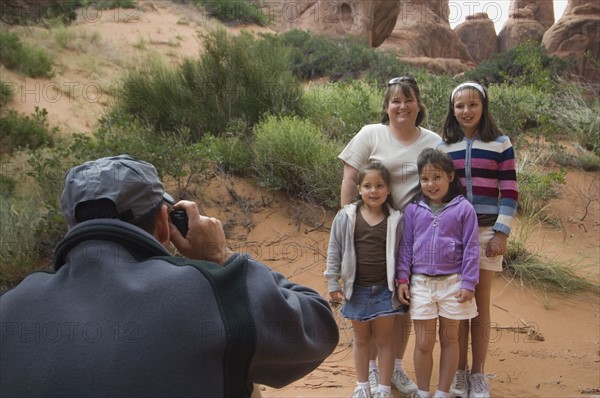 Father taking photograph of family. Date : 2007