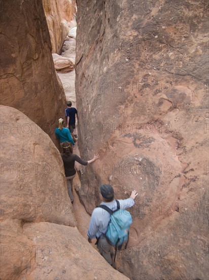 People walking through rock formations. Date : 2007