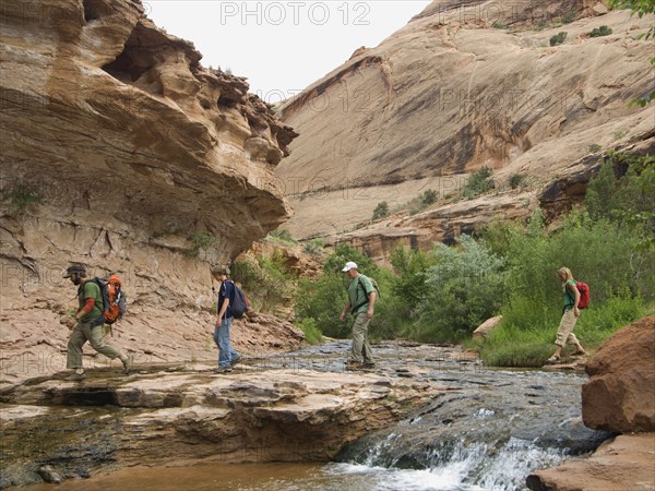 People hiking over stream. Date : 2007