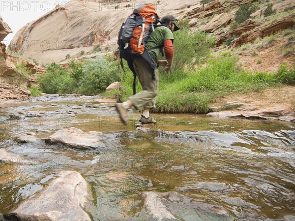 Man hiking through stream. Date : 2007