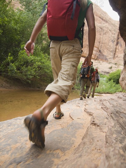 People hiking next to stream. Date : 2007