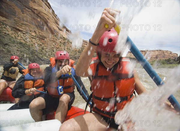 Group of people paddling in raft. Date : 2007