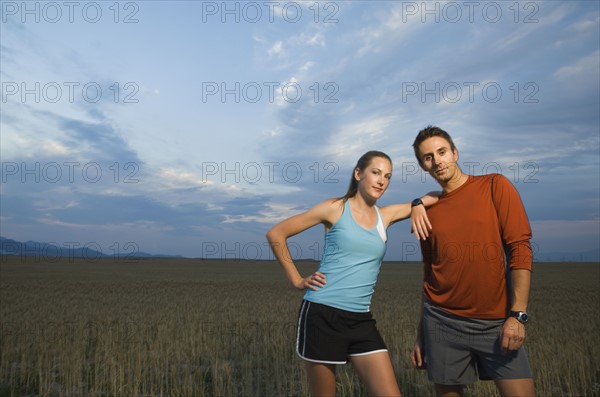 Couple in athletic gear next to field. Date : 2007