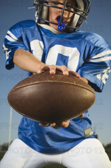 Young football player holding ball. Date : 2007
