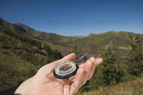 Close up of man holding compass, Utah, United States. Date : 2007