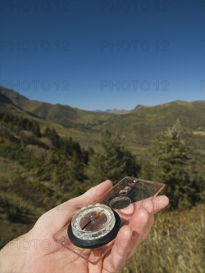 Close up of man holding compass, Utah, United States. Date : 2007