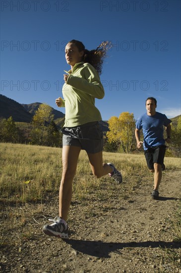Couple jogging on trail, Utah, United States. Date : 2007