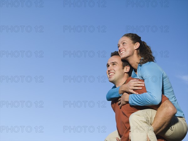 Man giving girlfriend piggy back ride, Utah, United States. Date : 2007